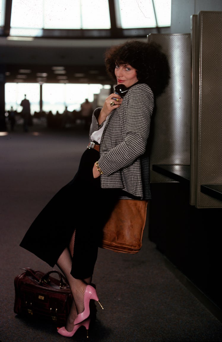 Portrait of Belgian-born fashion designer Diane von Furstenberg as she talks on a pay phone at John ...