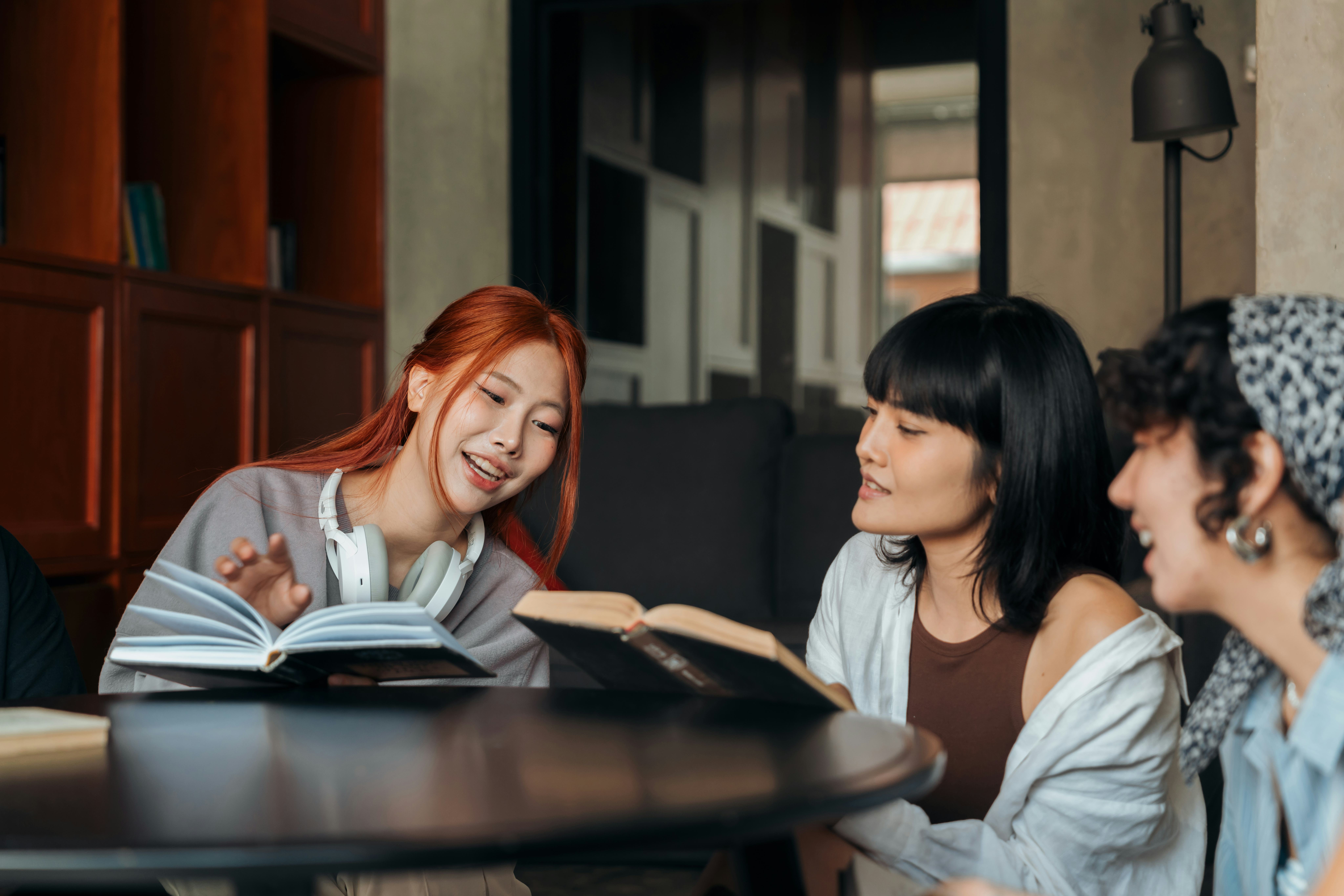 Three female friends at a book club meeting reading and sharing fun facts about each other and thems&hellip;