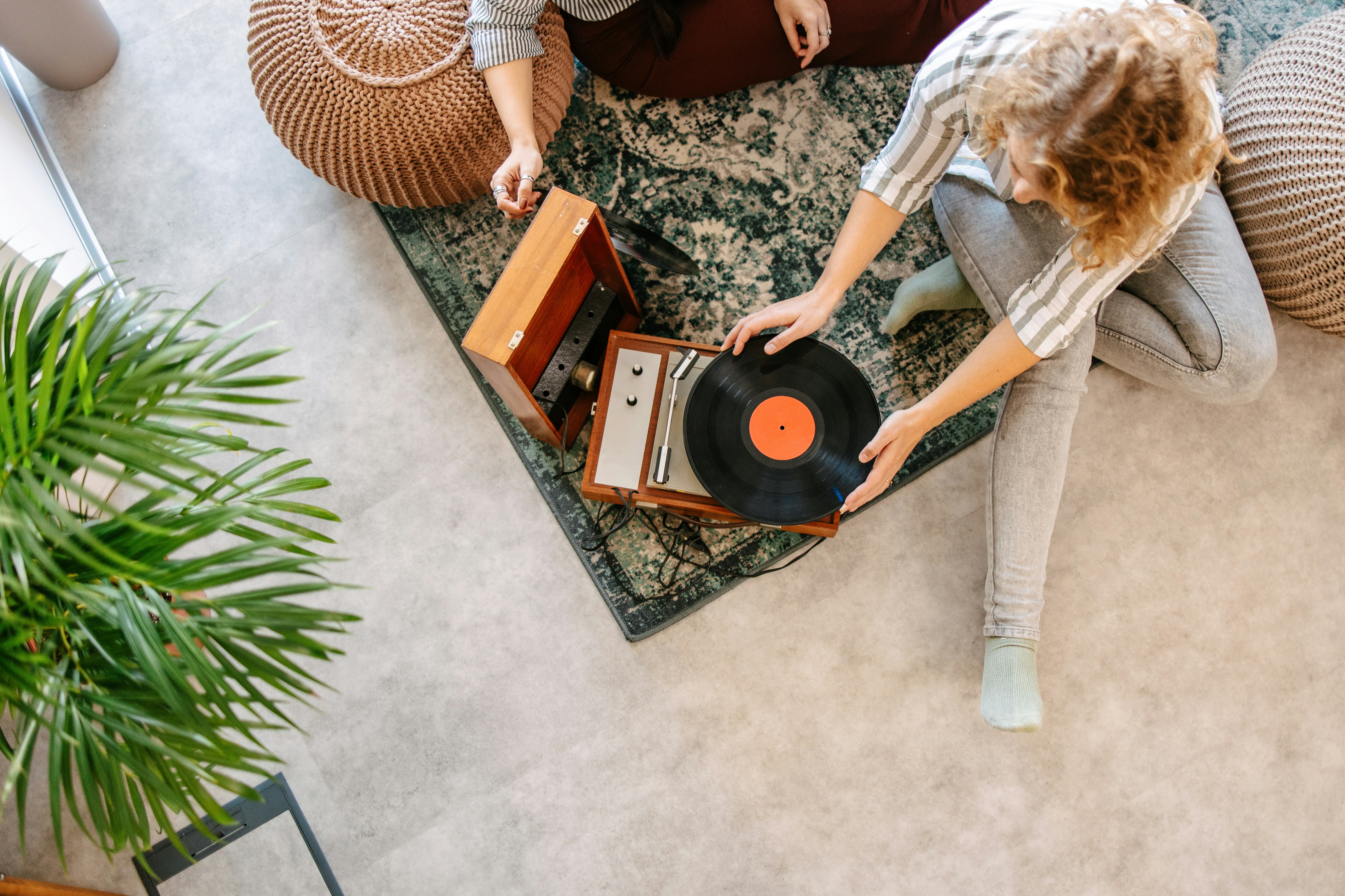 Two female friends looking at their vinyl collections after one shared it as her fun fact about me.