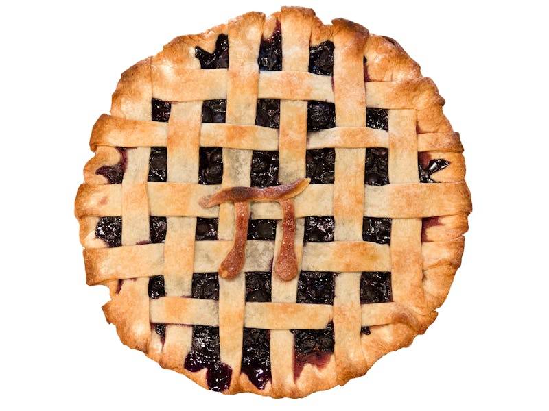 High-angle view of homemade blueberry pie with lattice top and golden-brown pastry dough "pi" symbol...