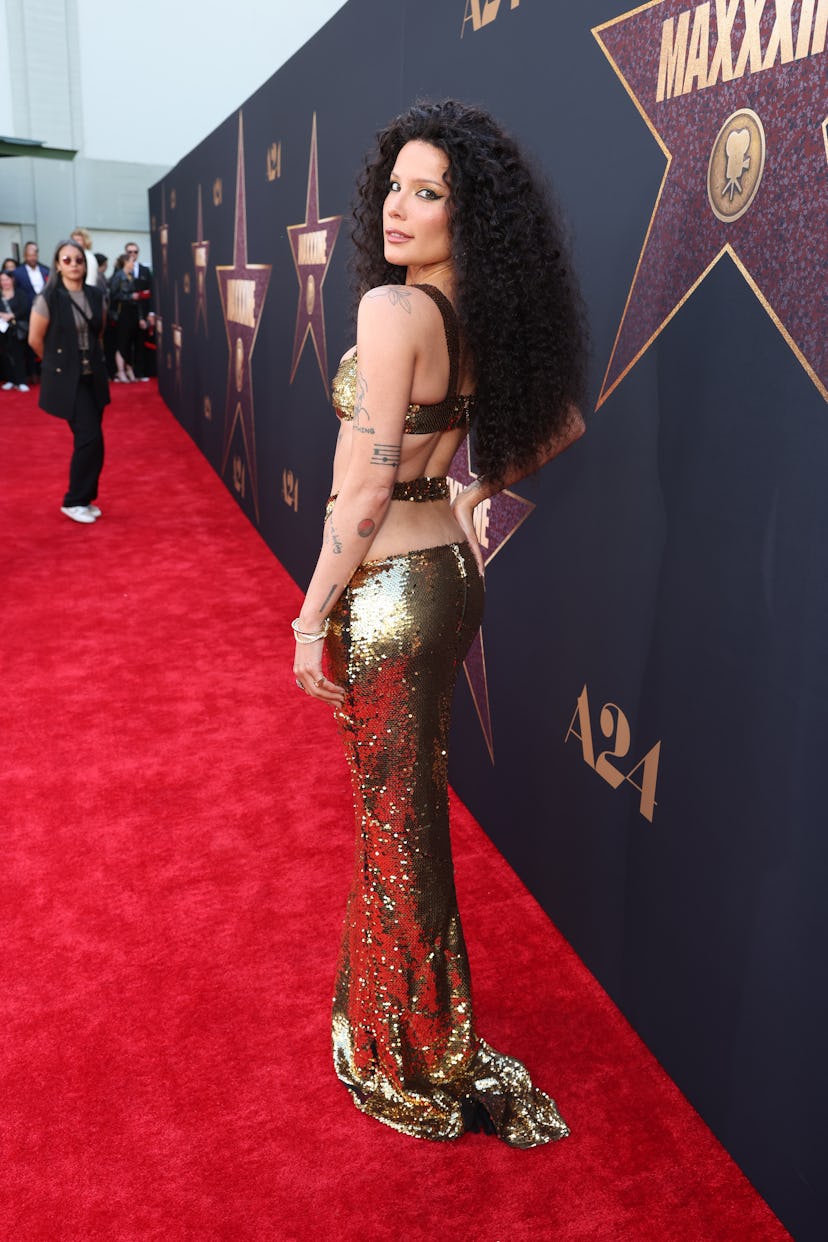 Halsey wears a sequined gold two-piece to attend the world premiere of A24’s “MAXXXINE” on June 24, …