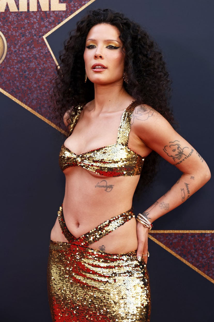 Halsey wears a sequined gold two-piece to attend the world premiere of A24’s “MAXXXINE” on June 24, …