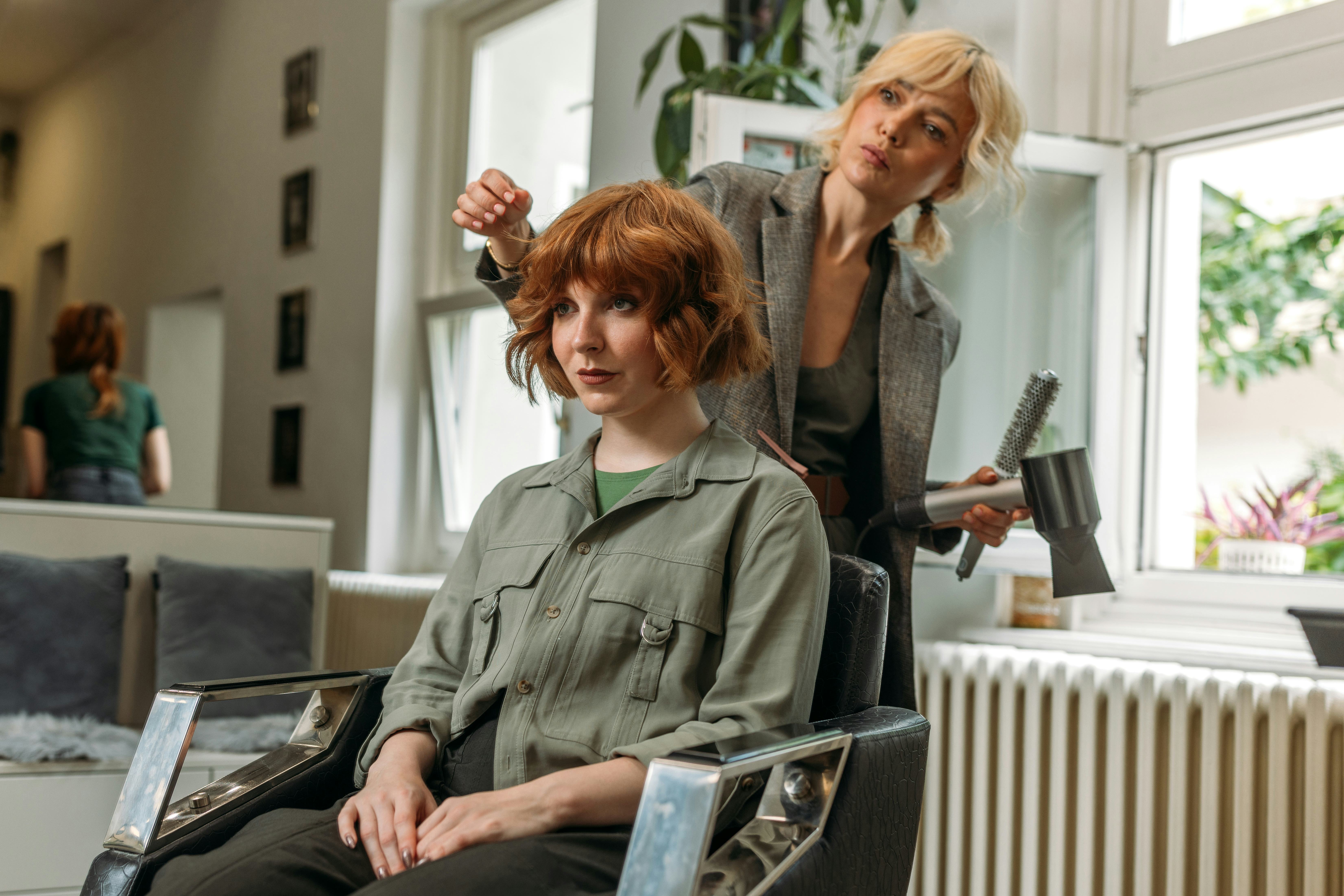 A woman sits in a salon chair and tells her hair stylist some fun facts about herself while she gets&hellip;
