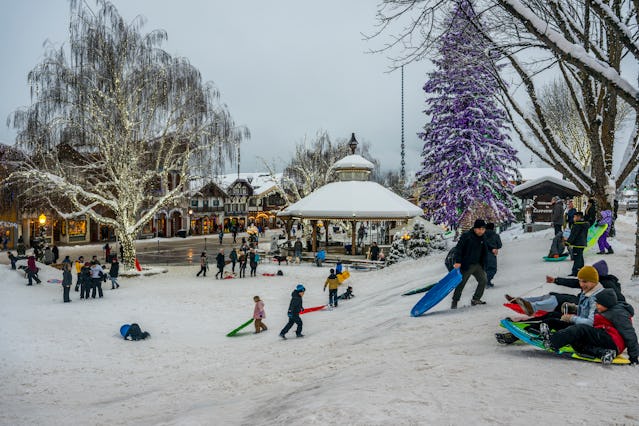People enjoying a sledding hill in winter in downtown Leavenworth, Washington.