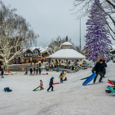 People enjoying a sledding hill in winter in downtown Leavenworth, Washington.