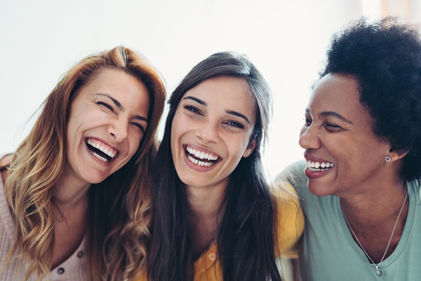 women laughing at bad jokes and puns