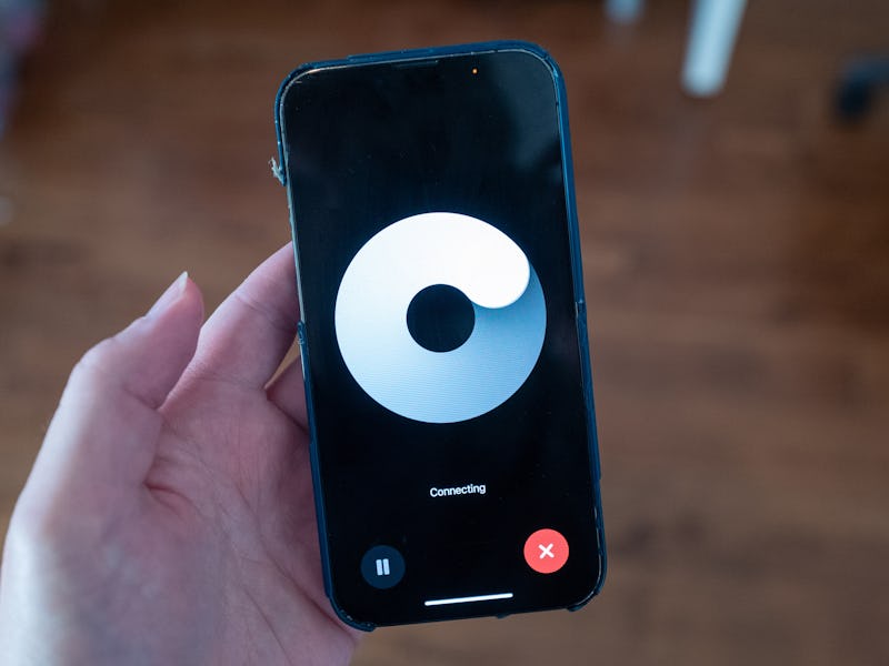 Close-up of a person's hand holding an iPhone and using the ChatGPT GPT-4o model released in May 202...