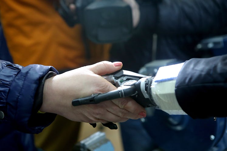 KHARKIV, UKRAINE - JANUARY 27, 2020 - Handshake of an organic and a bionic prosthetic hand is pictur...