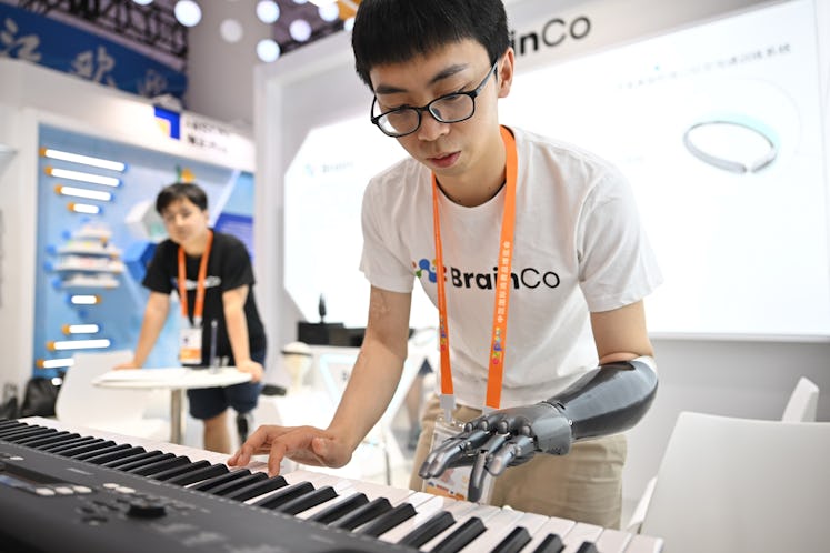 An exhibitor shows a bionic hand at the booth of east China's Zhejiang Province during the third Chi...