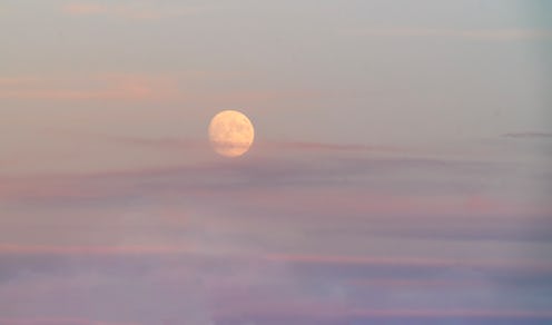 Beautiful pink and purple full moon rise at sunset
