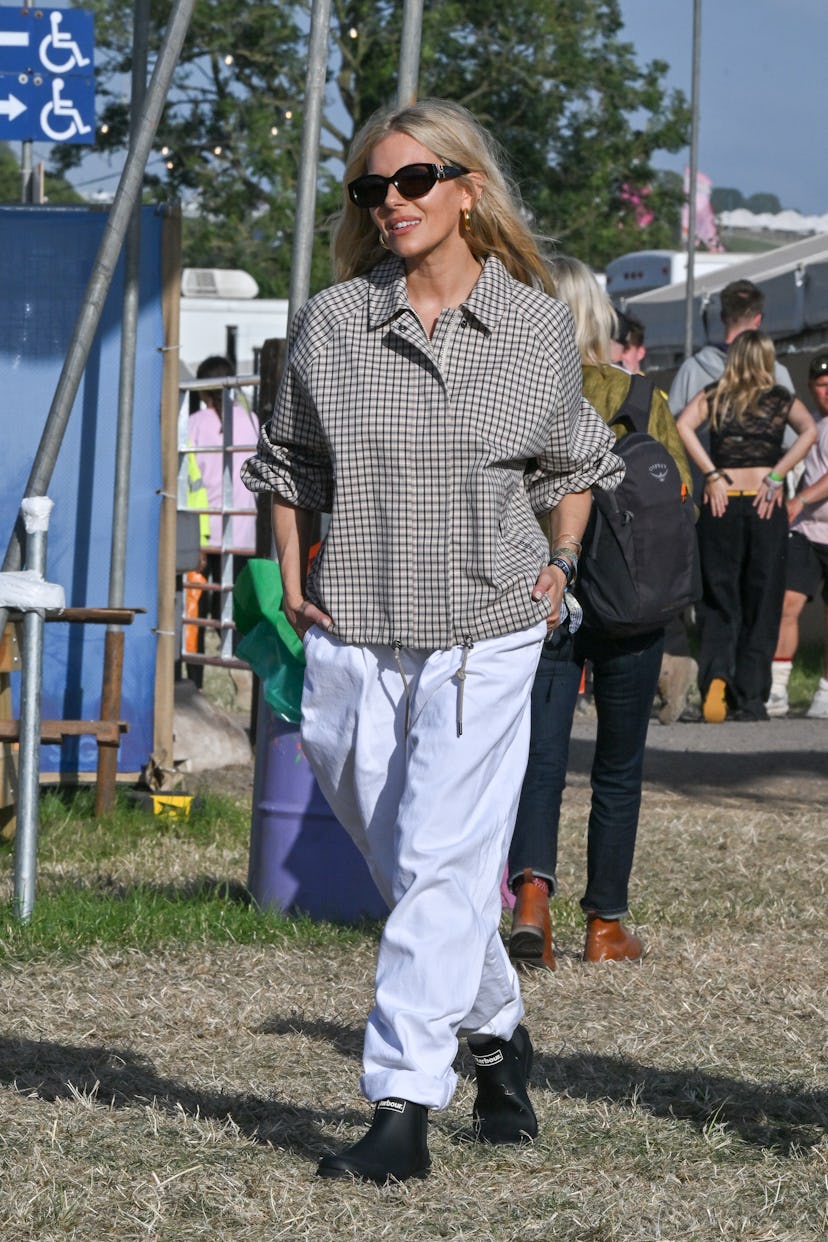 GLASTONBURY, ENGLAND - JUNE 28: Sienna Miller is seen on the first day of Glastonbury Festival wearing...