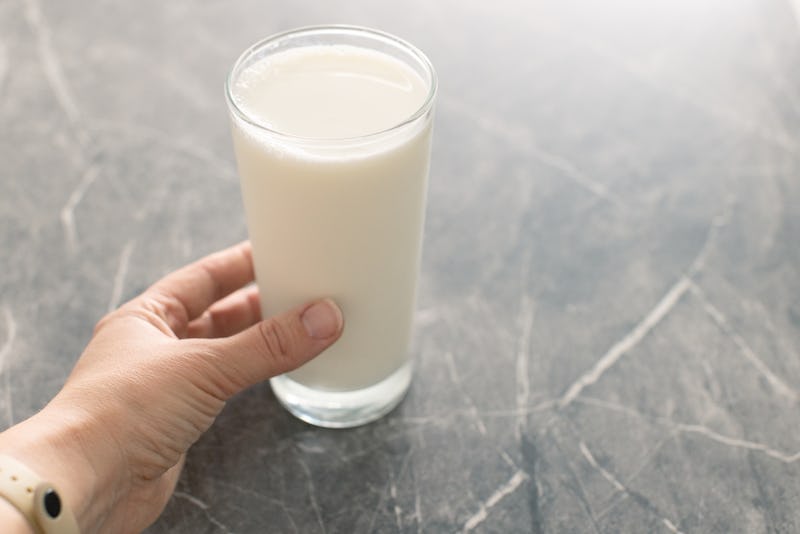 Glass of milk on a gray background Alternative milk