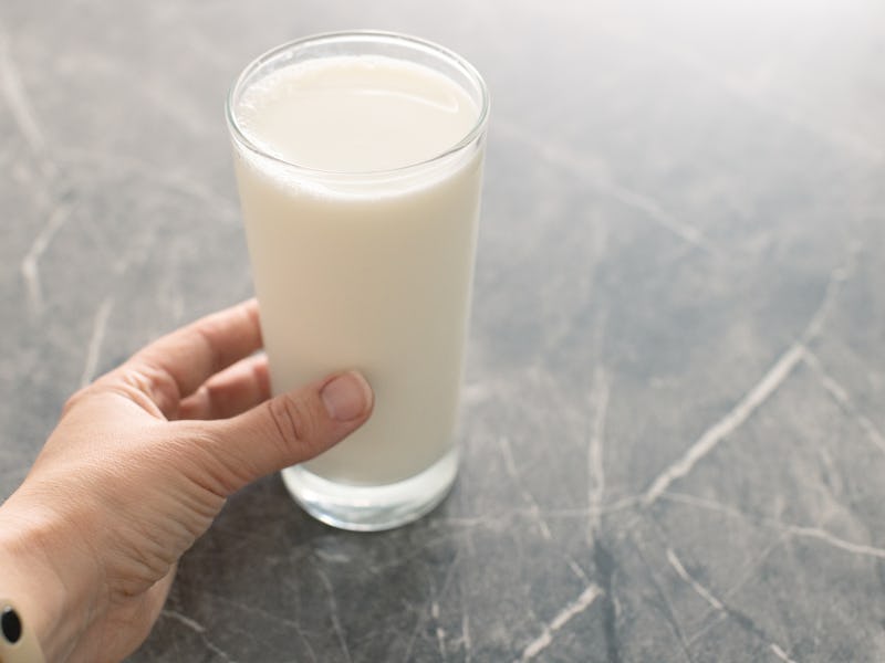 Glass of milk on a gray background Alternative milk