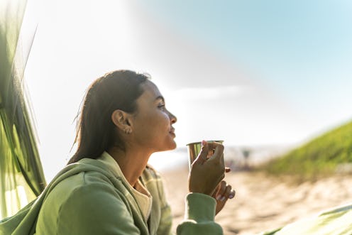 Young woman contemplating and looking at view on the beach