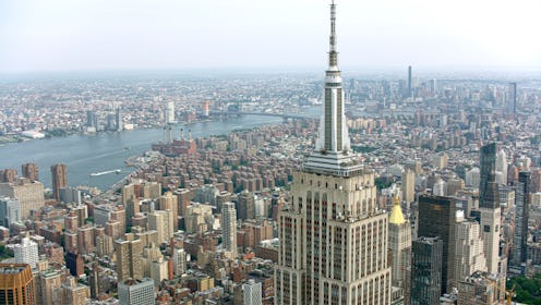 Manhattan, New York / U.S. - July 14, 2023: Aerial view of Empire State Building surrounding with Mi...
