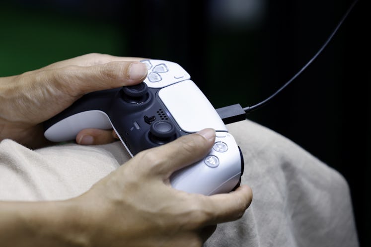 An attendee uses a controller while playing a video game on a Sony Group Corp. PlayStation 5 (PS5) v...