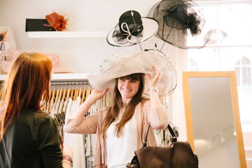 Two young women shopping for clothes in a shop