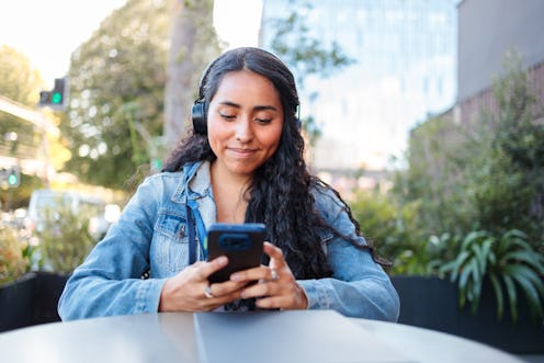 Al Fresco Finance Check: Young Latin Generation Z Woman Managing Banking Apps and Digital Investment...