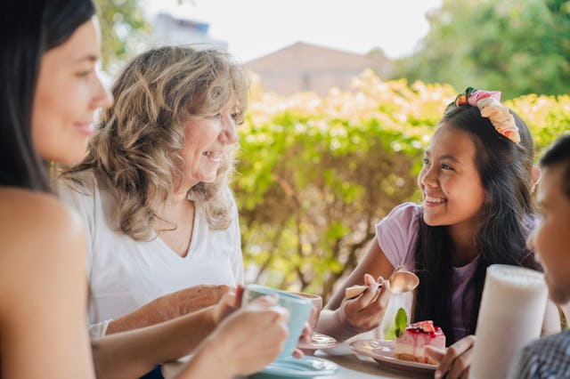 Multi-generation family talking and having fun in a Bakery while drinking coffee