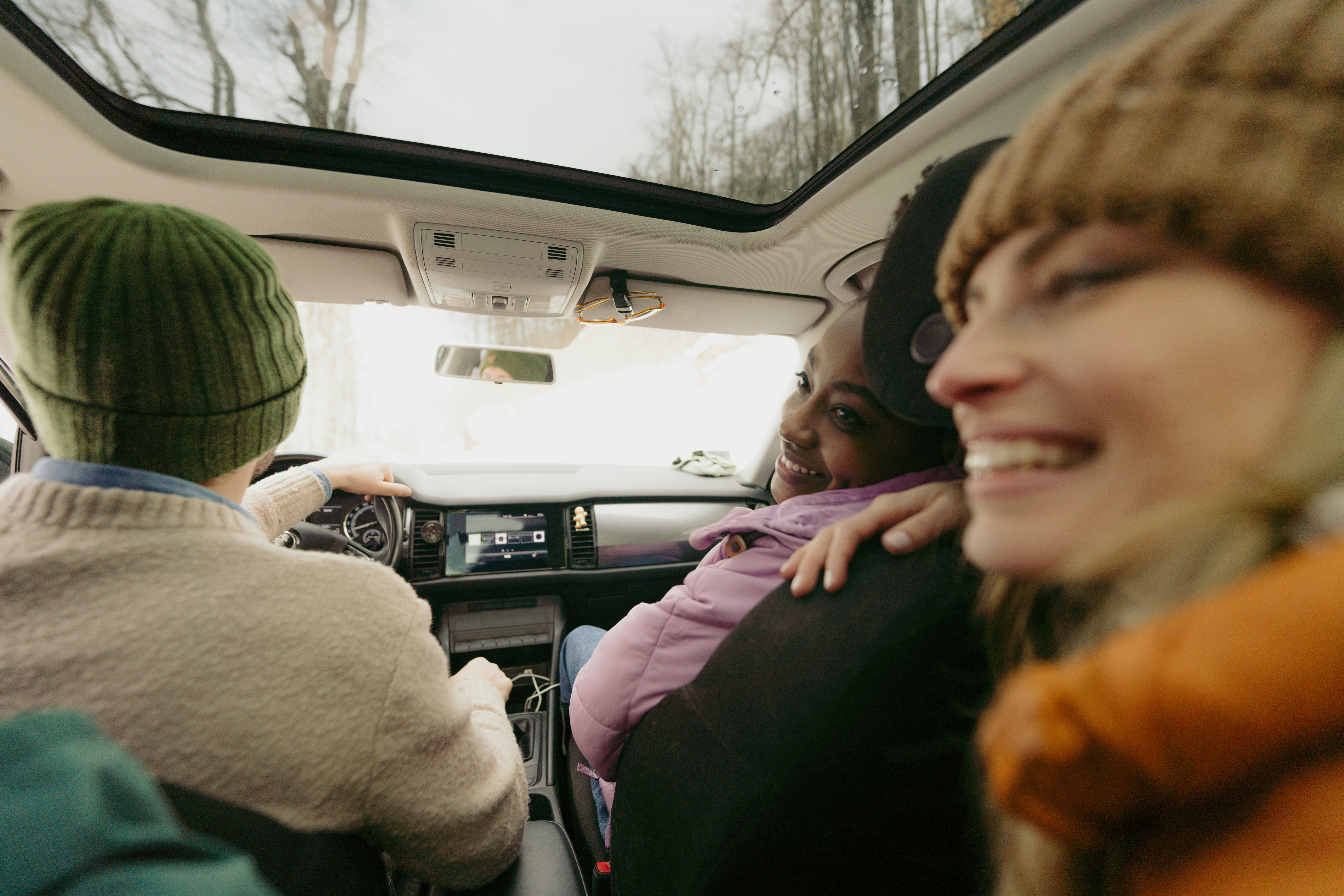 Friends on a road trip asking each other most likely to questions to pass the time