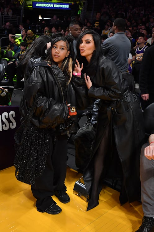 LOS ANGELES, CALIFORNIA - APRIL 09: Kim Kardashian (R) and North West attend a basketball game betwe...
