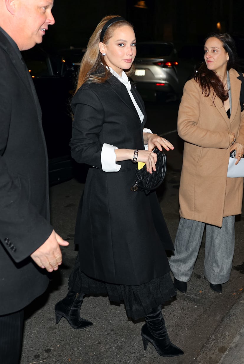 Jennifer Lawrence wears a black and white outfit to attend the Saks - Christian Dior holiday window …