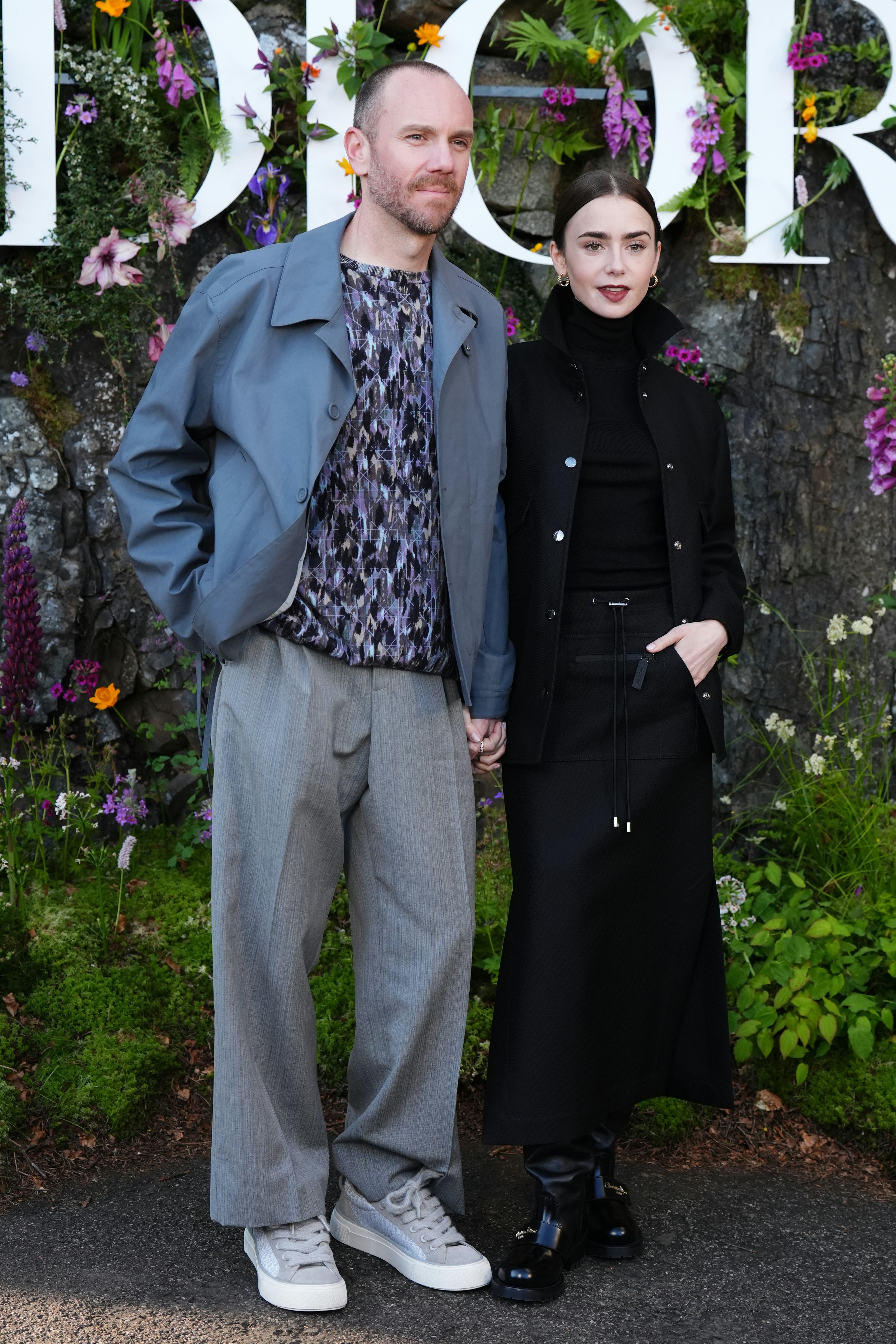 Charlie McDowell and Lily Collins attend the Dior Cruise 2025 show at Drummond Castle, Perthshire.