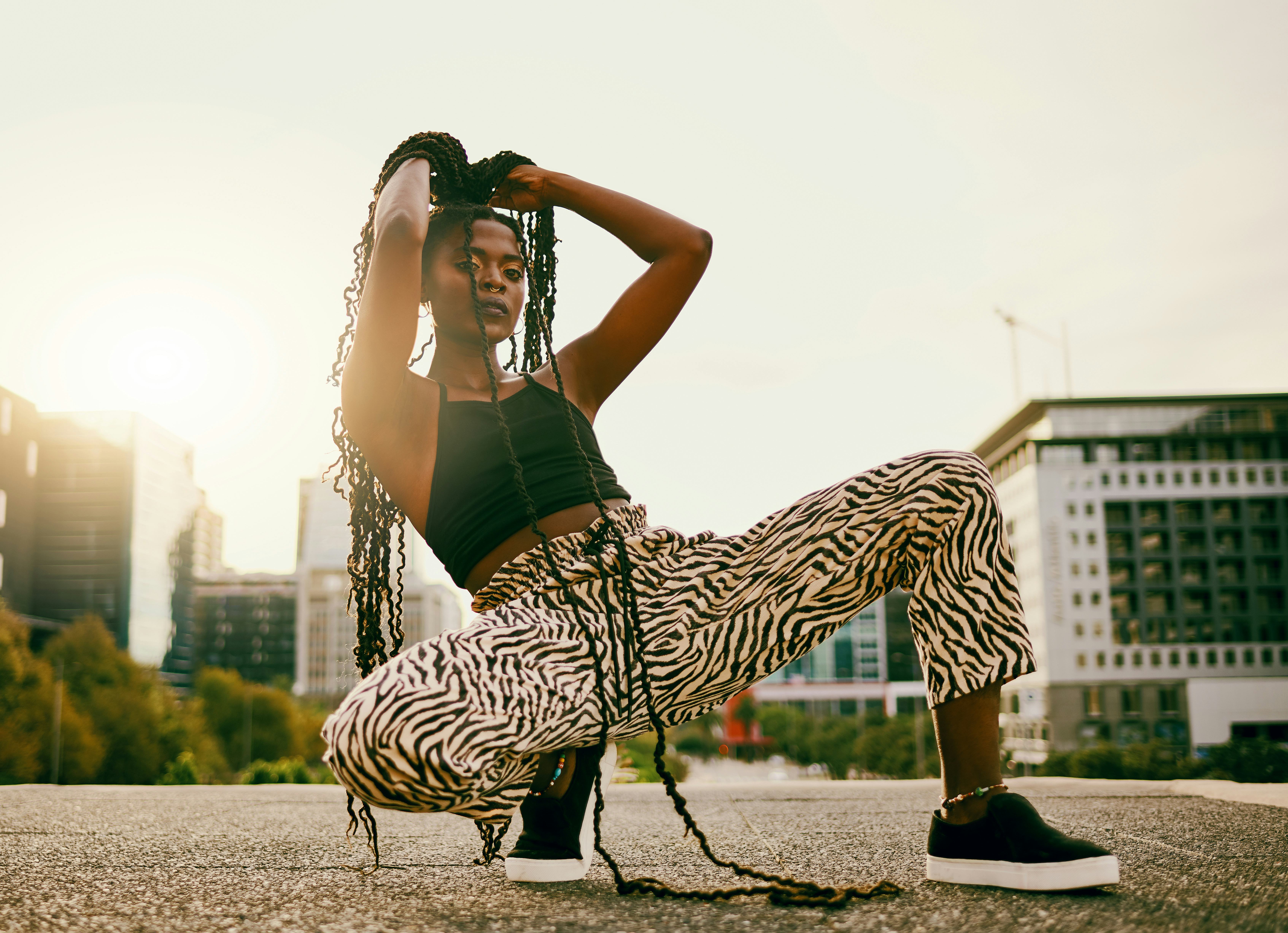 A woman squatting in zebra print pants with her hands in her hair being asked fashion most likely to&hellip;
