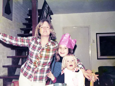 Mother with her two children celebrate Christmas at home.