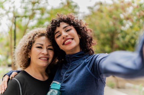 Mother and daughter taking a selfie on the public park - Camera point of view