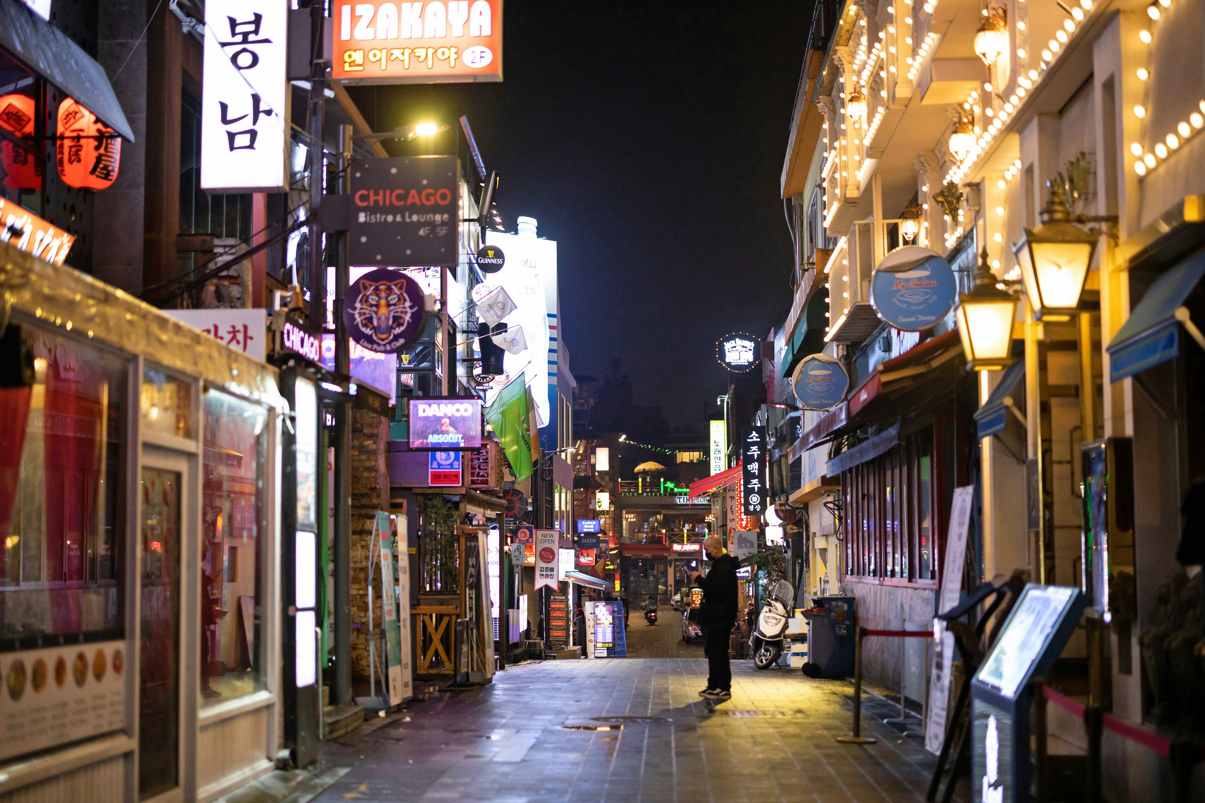A pub employee waits for a customer on an empty street at night in the Itaewon area of Seoul, South &hellip;