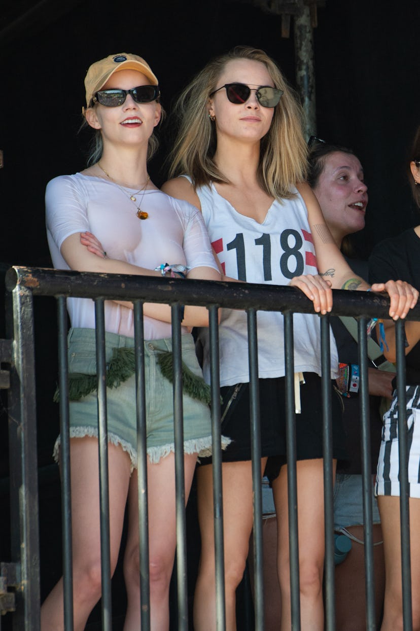 Anya Taylor-Joy and Cara Delevingne watch The Last Garden Party perform during day four of Glastonbu...