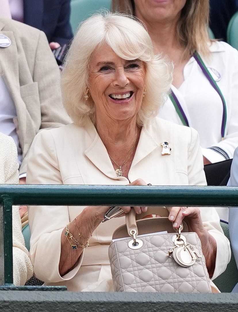 Queen Camilla watches on in the stands of Court One