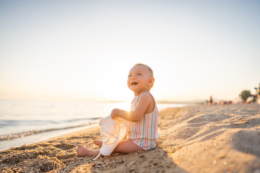 baby girl with hat.jpg?w=414&h=276&fit=crop&crop=focalpoint&dpr=2&fp x=0.5455&fp y=0 Baby girl with hat sitting at the beach in summer