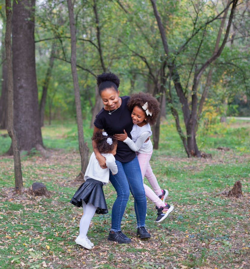 african american mother her.jpg?w=414&h=446&fit=crop&crop=focalpoint&dpr=2&fp x=0.5101&fp y=0 mother and her daughters hug in park