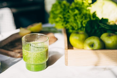 Detox diet concept: green vegetables on wooden table