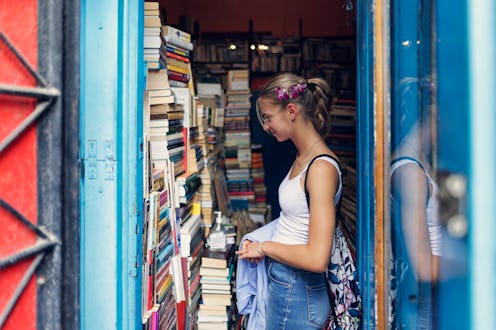 Teenage girl enjoying sightseeing city of Krakow, Poland.
She is browsing old, used books in Jewis...
