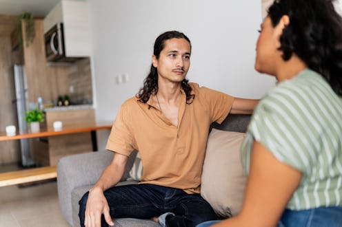 Mid adult couple arguing in living room at home