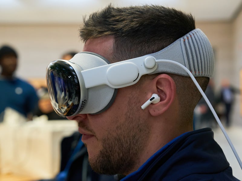 An employee of Rosellimac, an authorized reseller of Apple products, tries the Apple Vision Pro mixe...