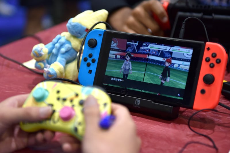 LONDON, ENGLAND - AUGUST 18: A competitor plays Pokemon on a Nintendo Switch console during the 2022...