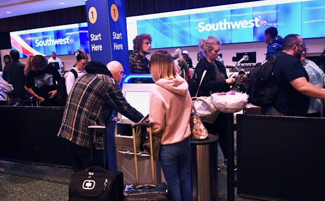 ORLANDO, FLORIDA, UNITED STATES - DECEMBER 22: Passengers are seen at the Southwest Airlines ticket ...