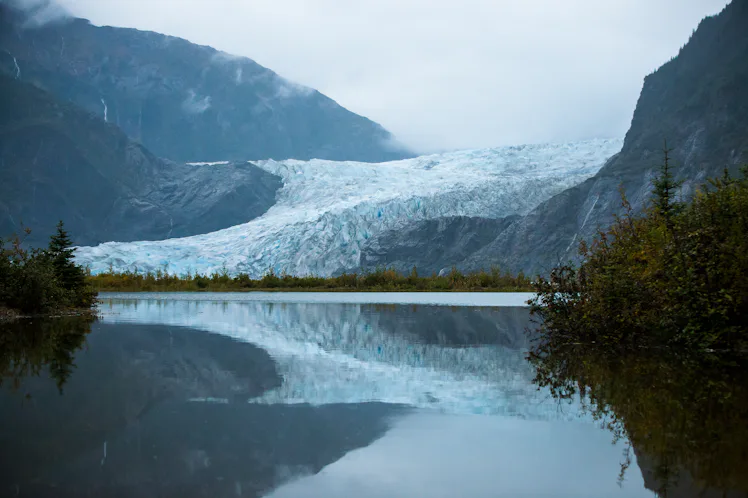 Mendenhall Glacier during an overcast day with reflection on the lake
