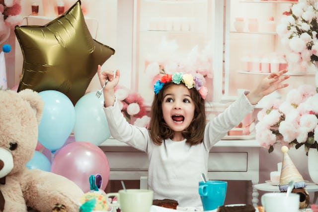 A girl celebrates at a birthday party. Today, the average birthday for a kid costs over $300 without...