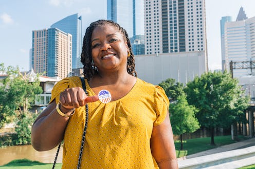 Standing with the Houston Texas Skyline in the background with an "I Voted" Sticker for a Presidenti...
