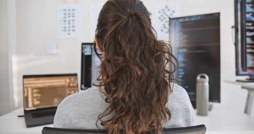 Hispanic Latin American woman, software engineer developer use computer at home office, work on prog...