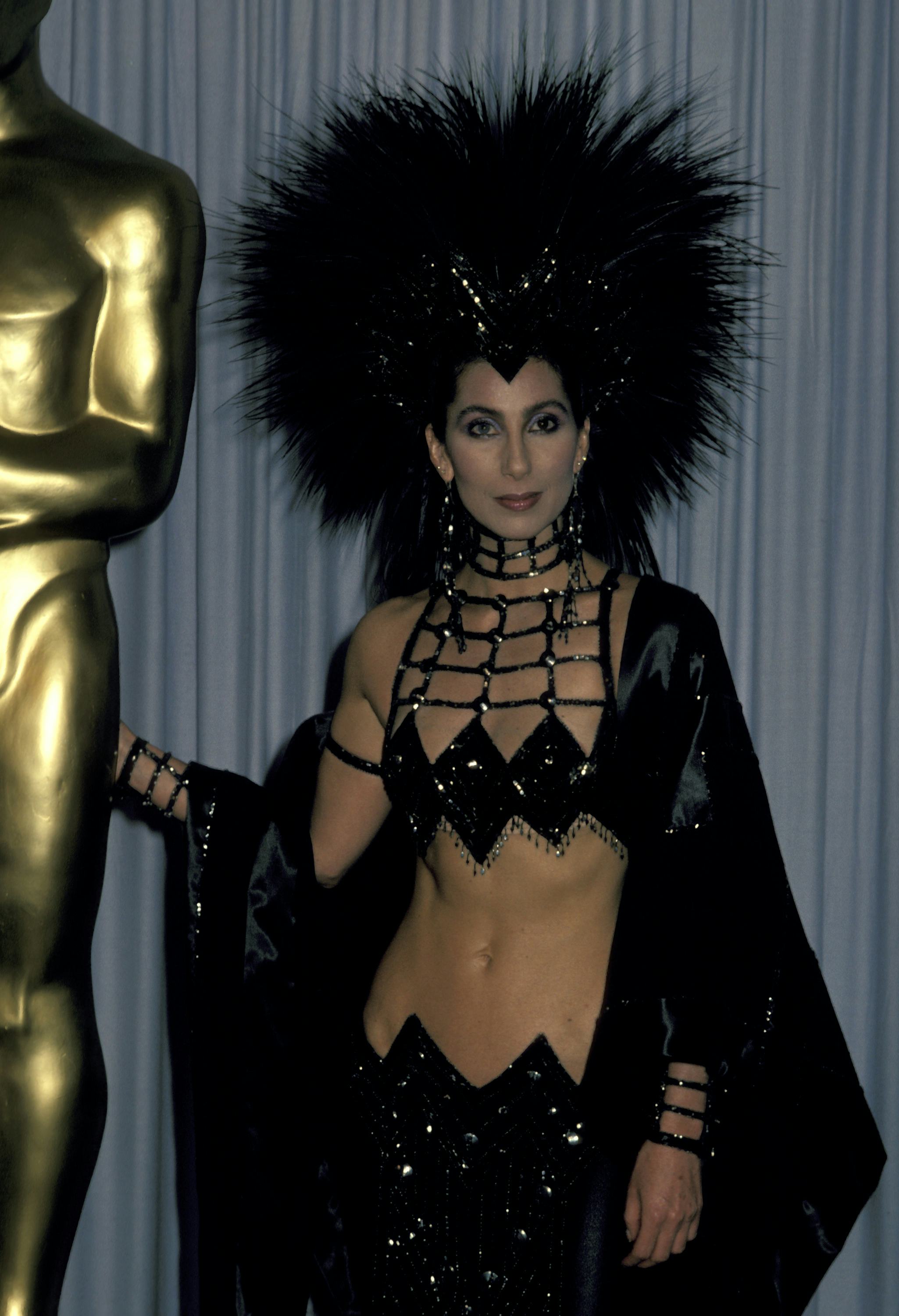 Cher wearing a cutout Bob Mackie outfit, one of her most revealing looks of all time, at the 1986 Ac&hellip;