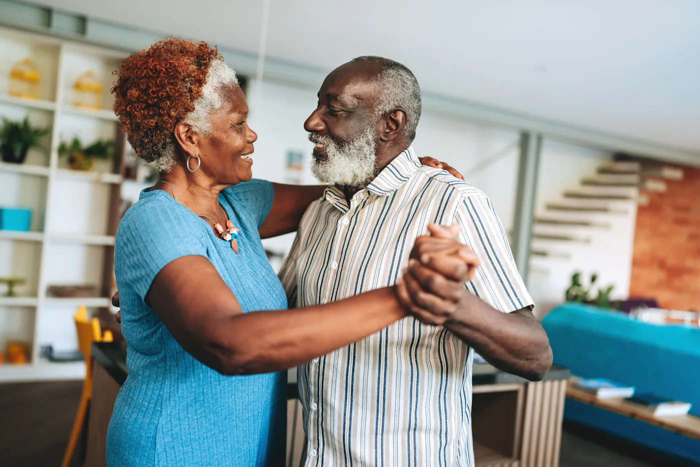 Senior couple dancing at home