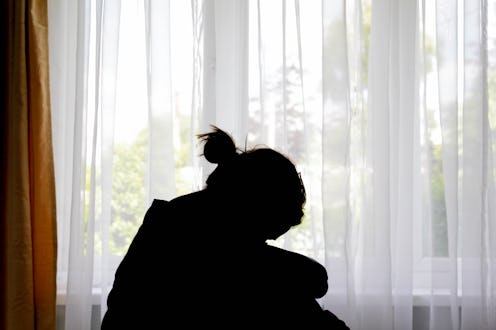 Silhouette of a woman in front of the window