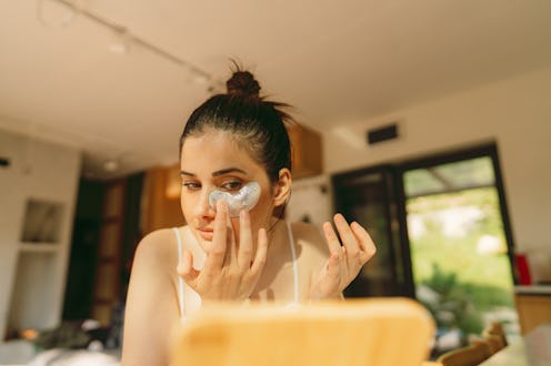 Photo of a young woman doing her skincare routine