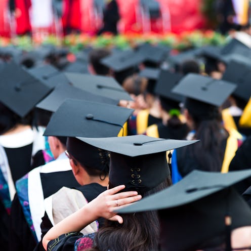 Rear view of graduation caps during commencement.